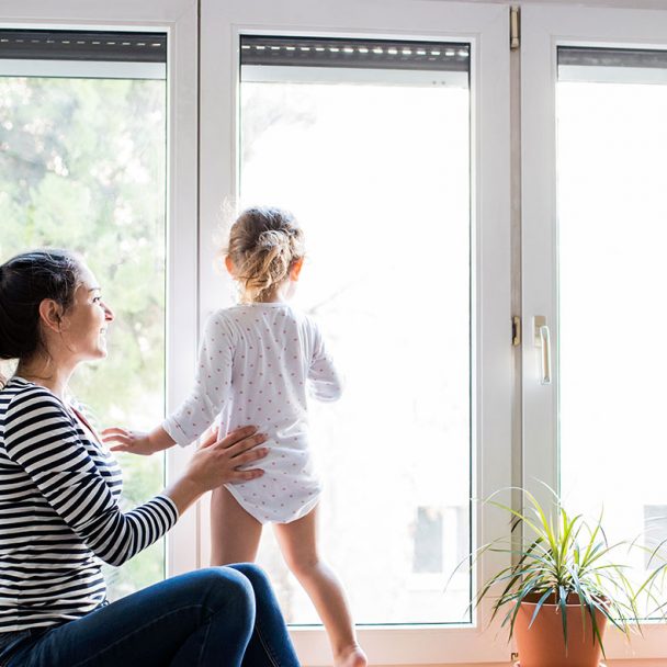 Mother and daughter by vinyl window