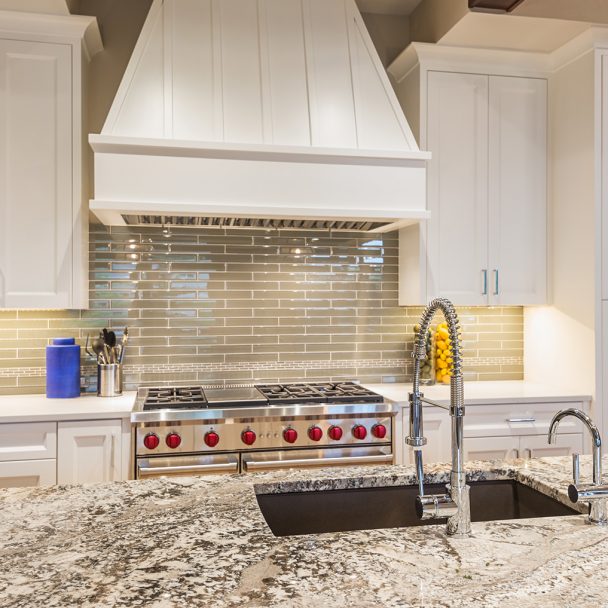 Modern white cabinets and a granite kitchen island
