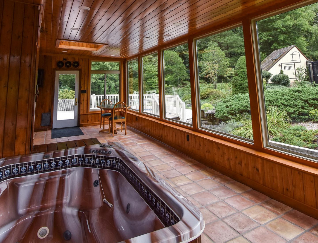 Hot tub in sunroom with nature view