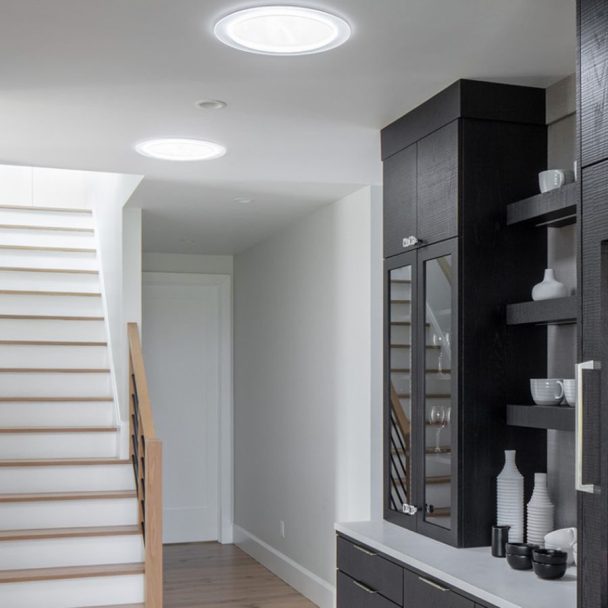 Velux sun tunnel skylight in dark hallway of home