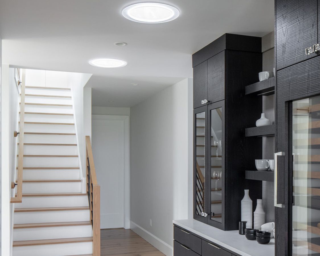 Velux sun tunnel skylight in dark hallway of home